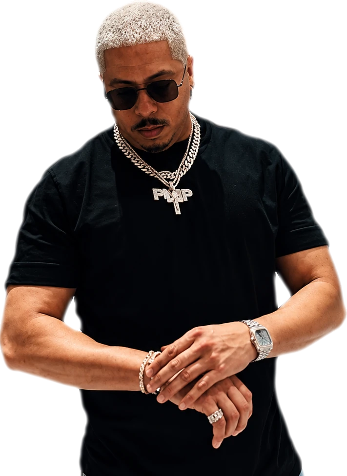 PURPLE in a black tee, arms crossed, checking his watch
